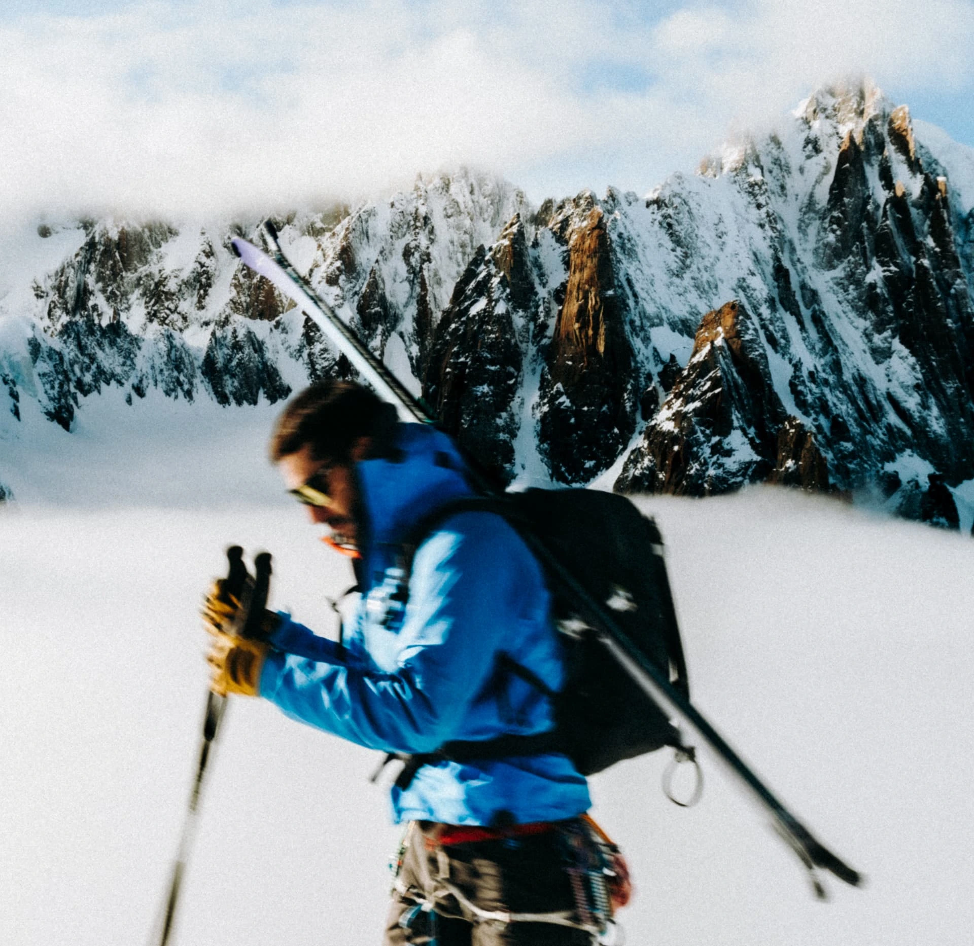 Ski tourer climbing in front of the Mont Blanc aiguilles