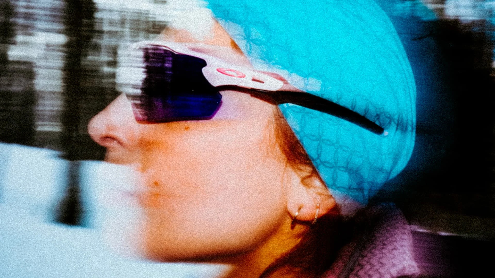 Close portrait of an athlete in blue sunglasses captured in motion